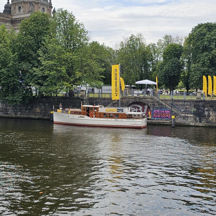 Bick vom linken Ufer über den Fluß, eine alte kleine Jacht ist zu sehen.